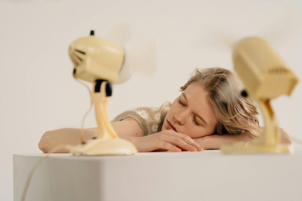 A cooling station with fans and woman laying on her belly looking relaxed
