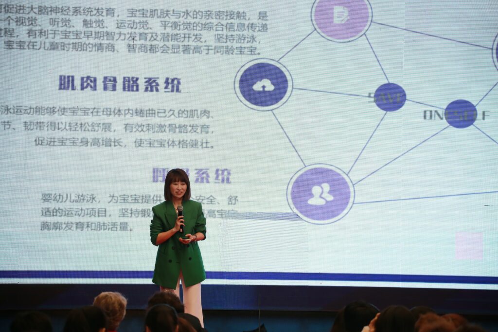 Sunny baby swimming teacher speaking at the international summit