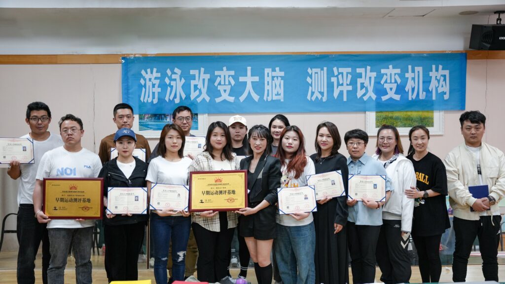 Sunny and other baby swimming teachers holding certificates